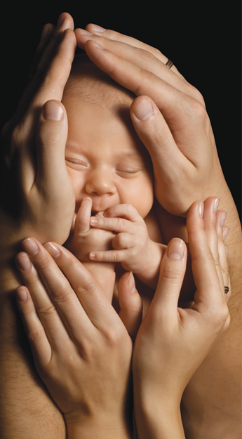 Baby being cradled by hands